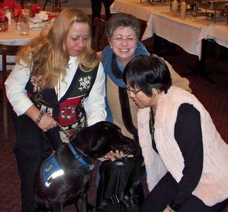 Linde Decarlo, Darcy Downie and Margaret Wong with leader dog in training Bradley