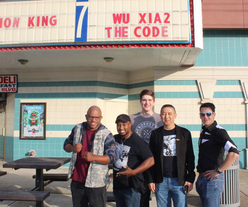 Johnny Wu group in front of movie marquis