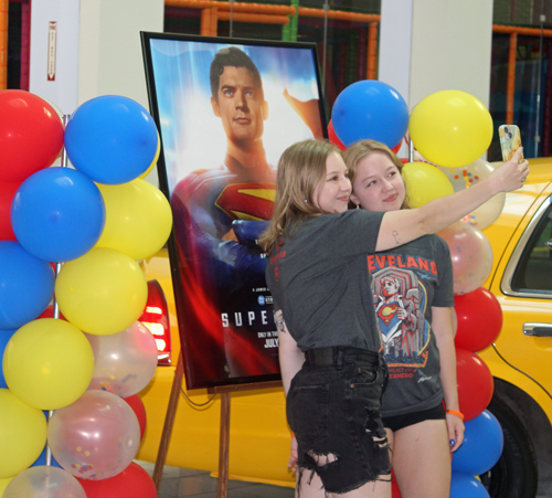 Girls taking selfie with Superman photo