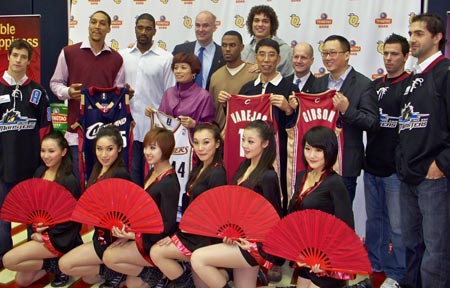 Len Komoroski poses with Tsingtao and Cavalier executives,Cleveland Cavalier and Lake Erie Monster players and the Tsingtao Dancers