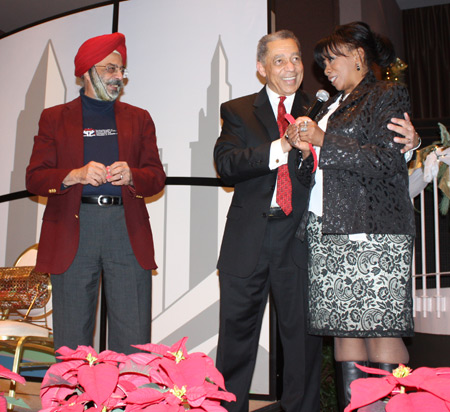 a lucky winner receives the good news from Leon Bibb after Paramjit Singh pulled her raffle ticket