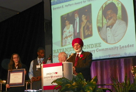 Ratanjit Sondhe accepting award at Project Love