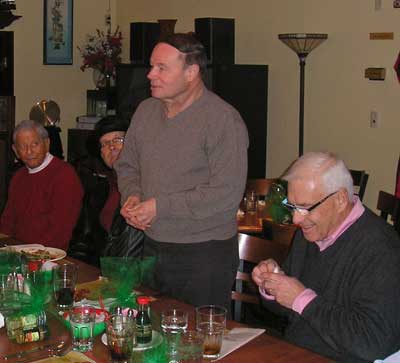 Allyn Adams speaking as Marshall Bedol, Thomas Mulready and Gordy Priemer listen