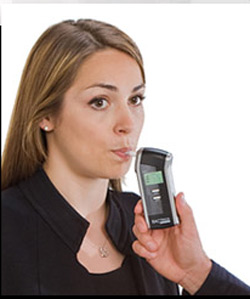 girl blowing into BACtrack personal breathalyzer